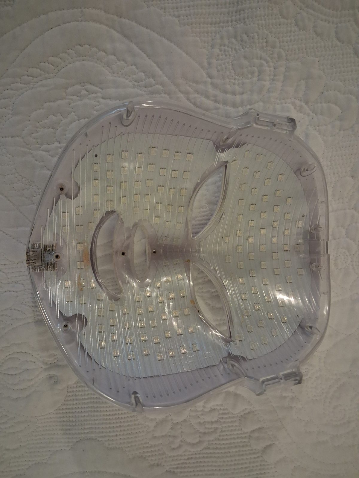 Inside of an older unidentified rigid face mask showing its discrete LED array and USB-A socket